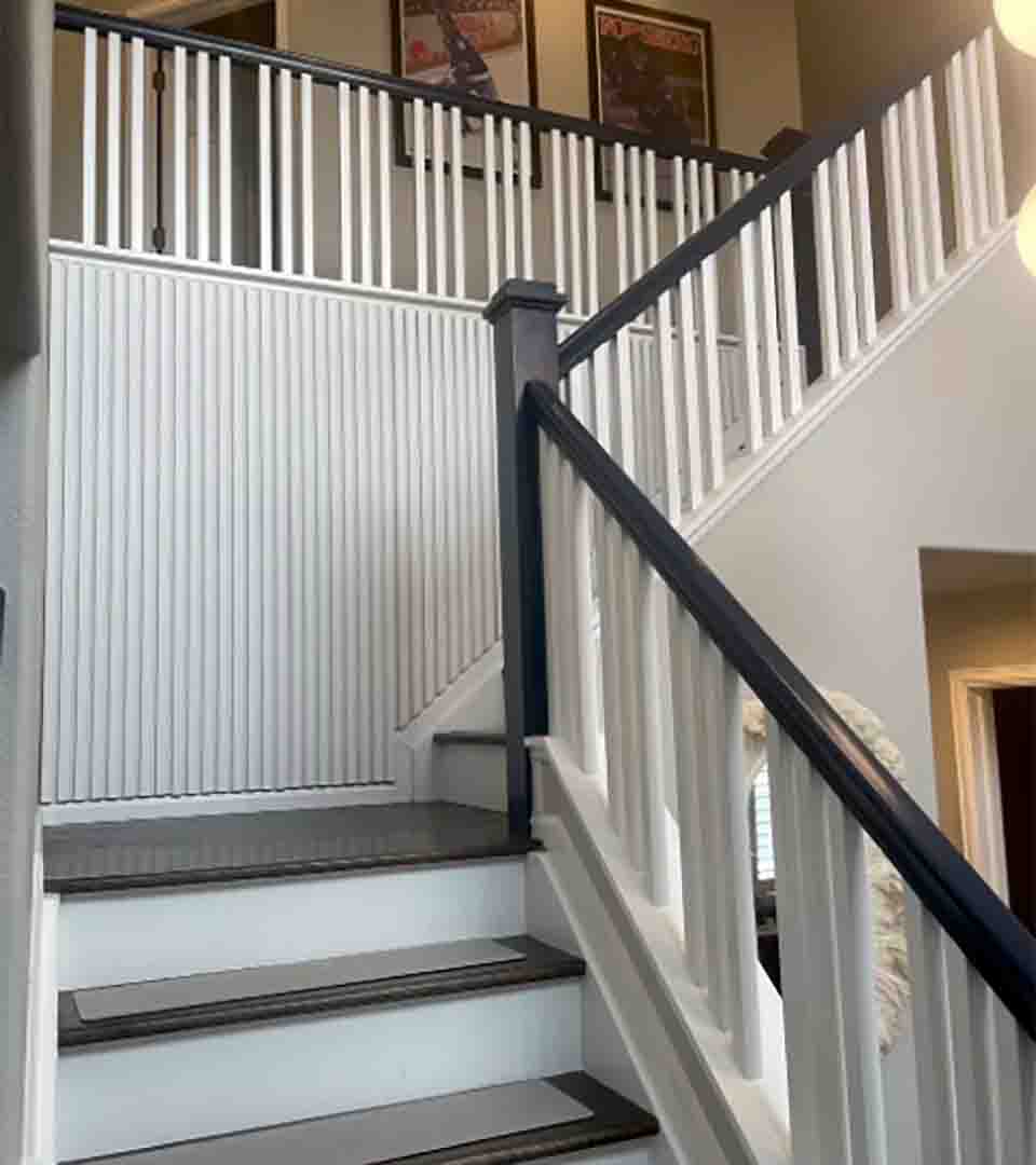 Vertical wood slat wall installation along a staircase, Denver, Colorado