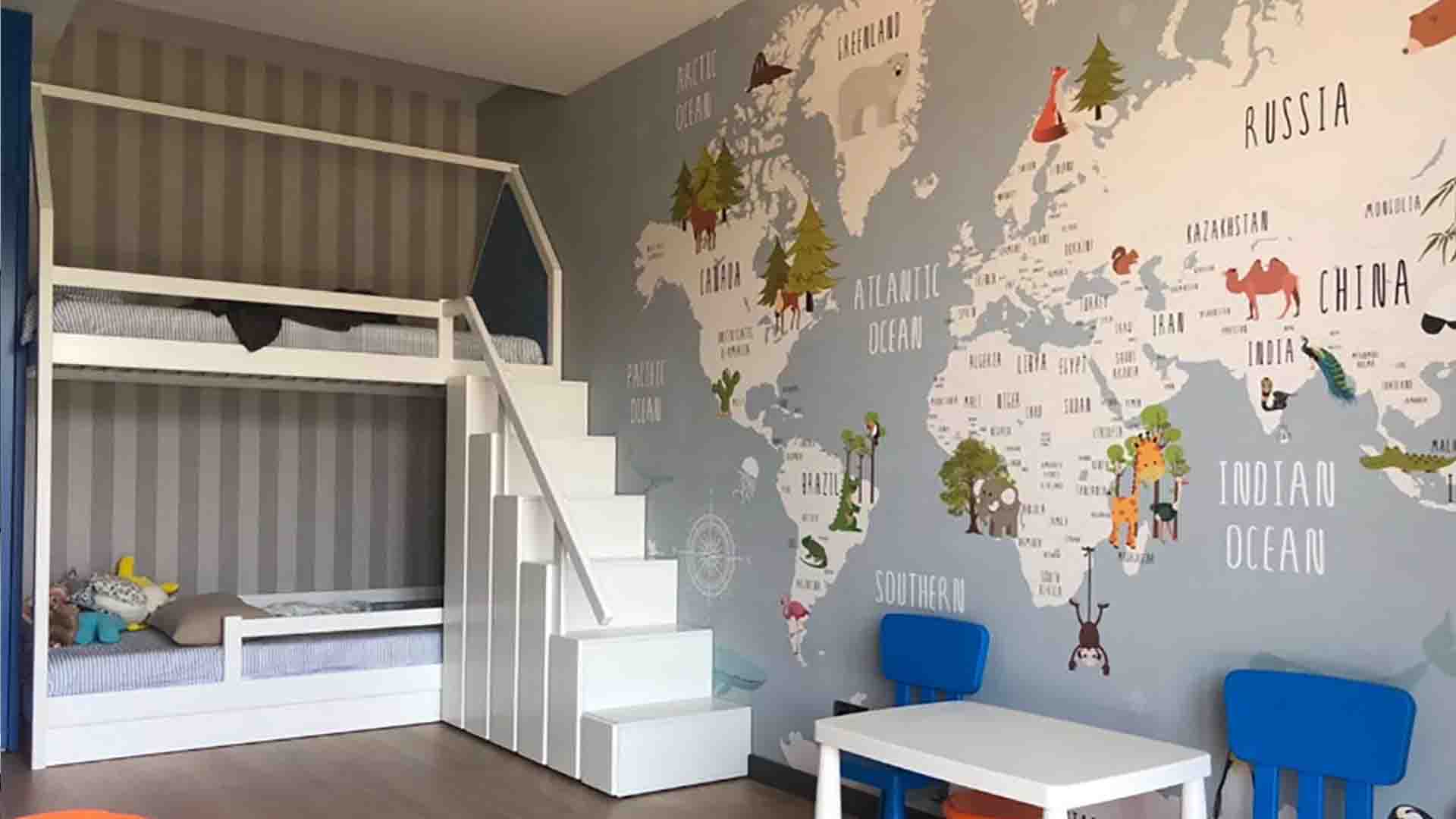 Wallpaper installation in a kids’ room with a world map mural accent wall, Arvada, Colorado